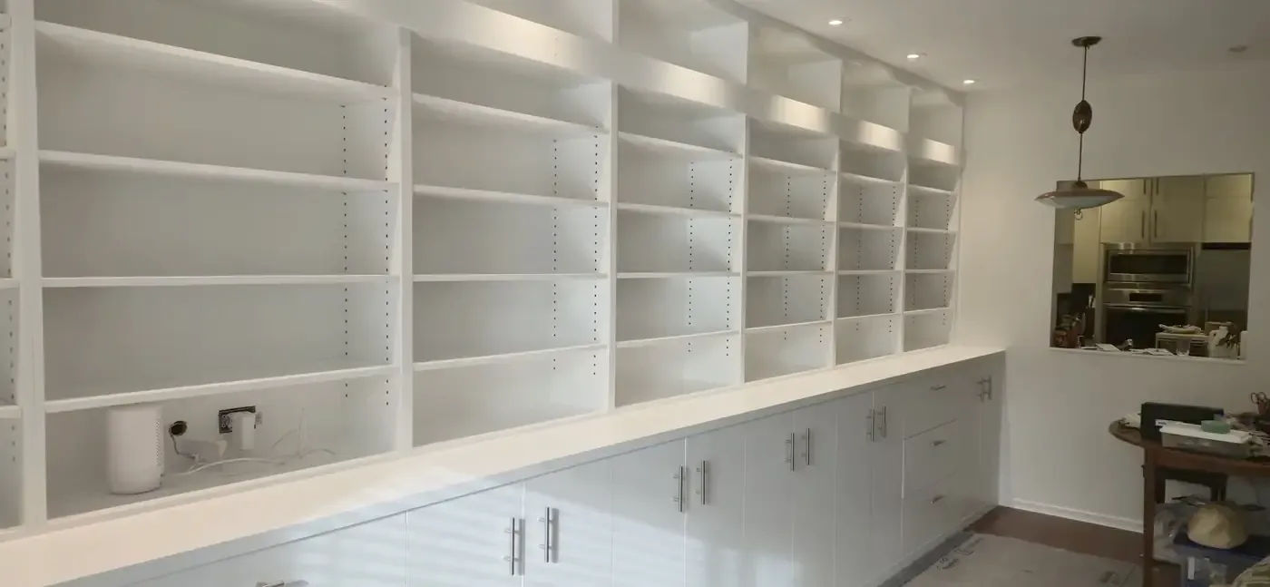 Built-in white shelving and cabinetry with a clean painted finish