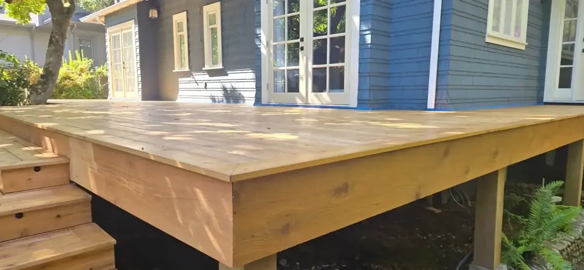 Newly refinished exterior deck beside the painted home