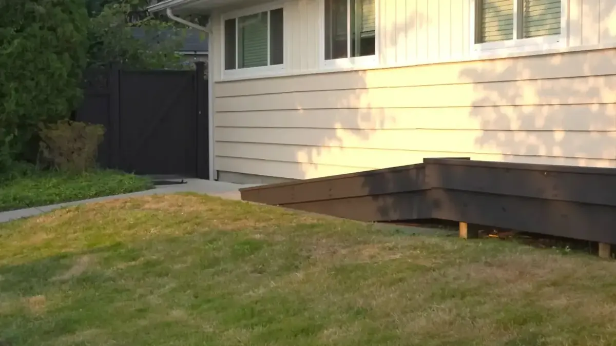 Freshly painted exterior siding with a low-profile entry ramp