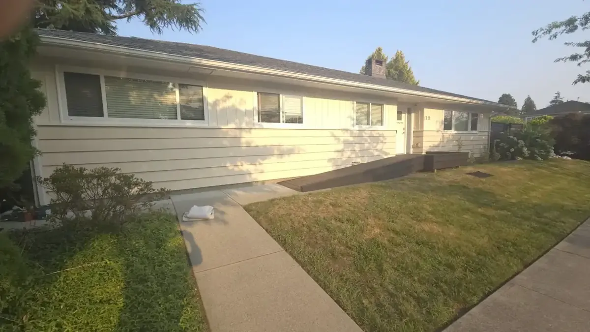 Wide view of freshly painted house exterior and front lawn