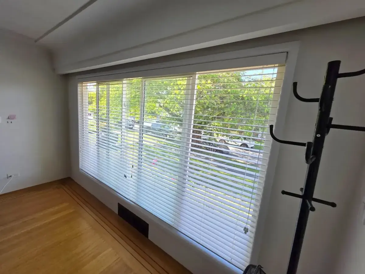 Bright room with newly painted walls and large window blinds