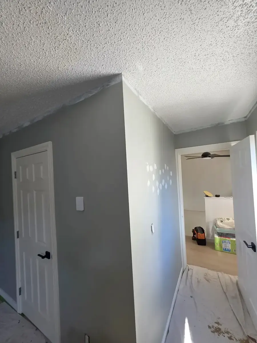 Hallway with freshly painted grey walls and white trim